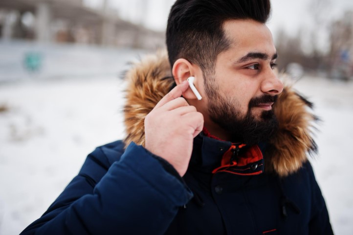 beard-indian-man-wear-jacket-cold-winter-day-mobile-earphones-ears